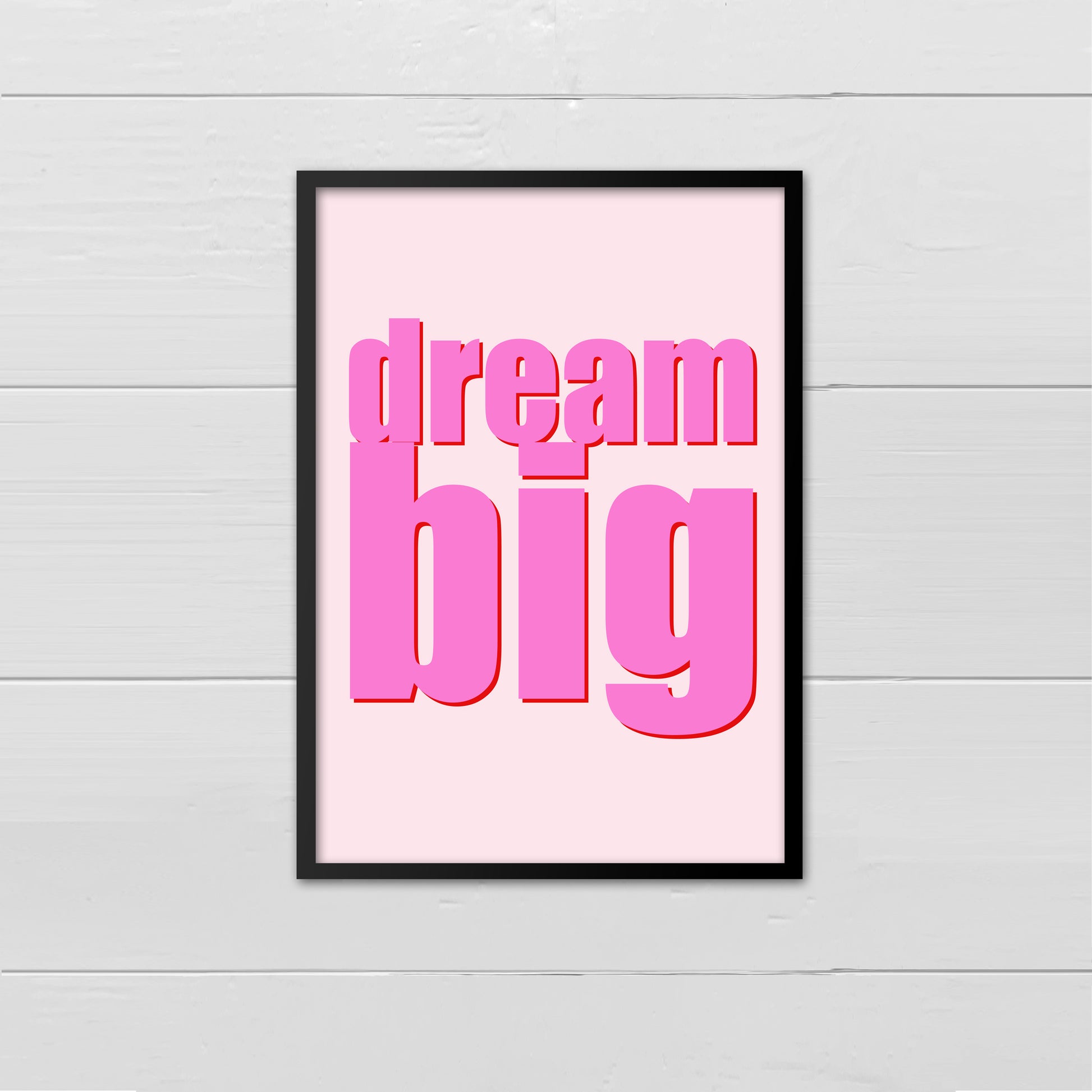 Portrait style print with the words Dream Big printed in large lowercase letters in bright pink with a bright red drop shadow,  on top a pale pink background
