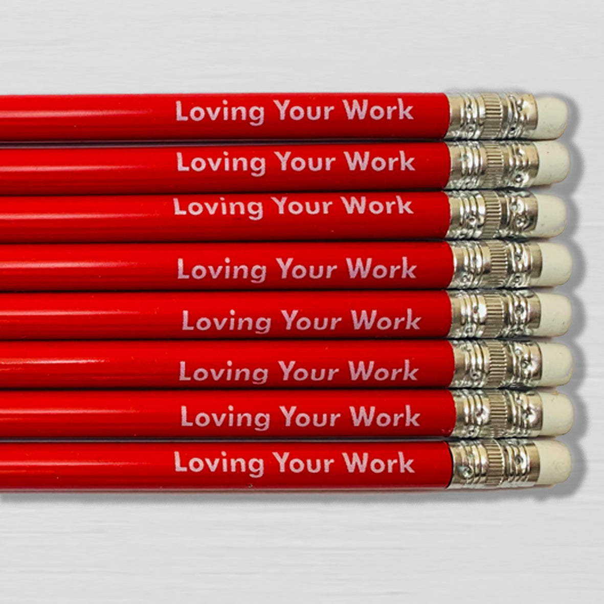 Number Ninety Five, Loving Your Work, 8 sharpened red pencils with white rubber tips, gift wrapped in a kraft box, with 8 pencils stating the phrase Loving Your Work written on them in white text.
